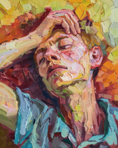 Sick man laying on his back with hand on his forehead